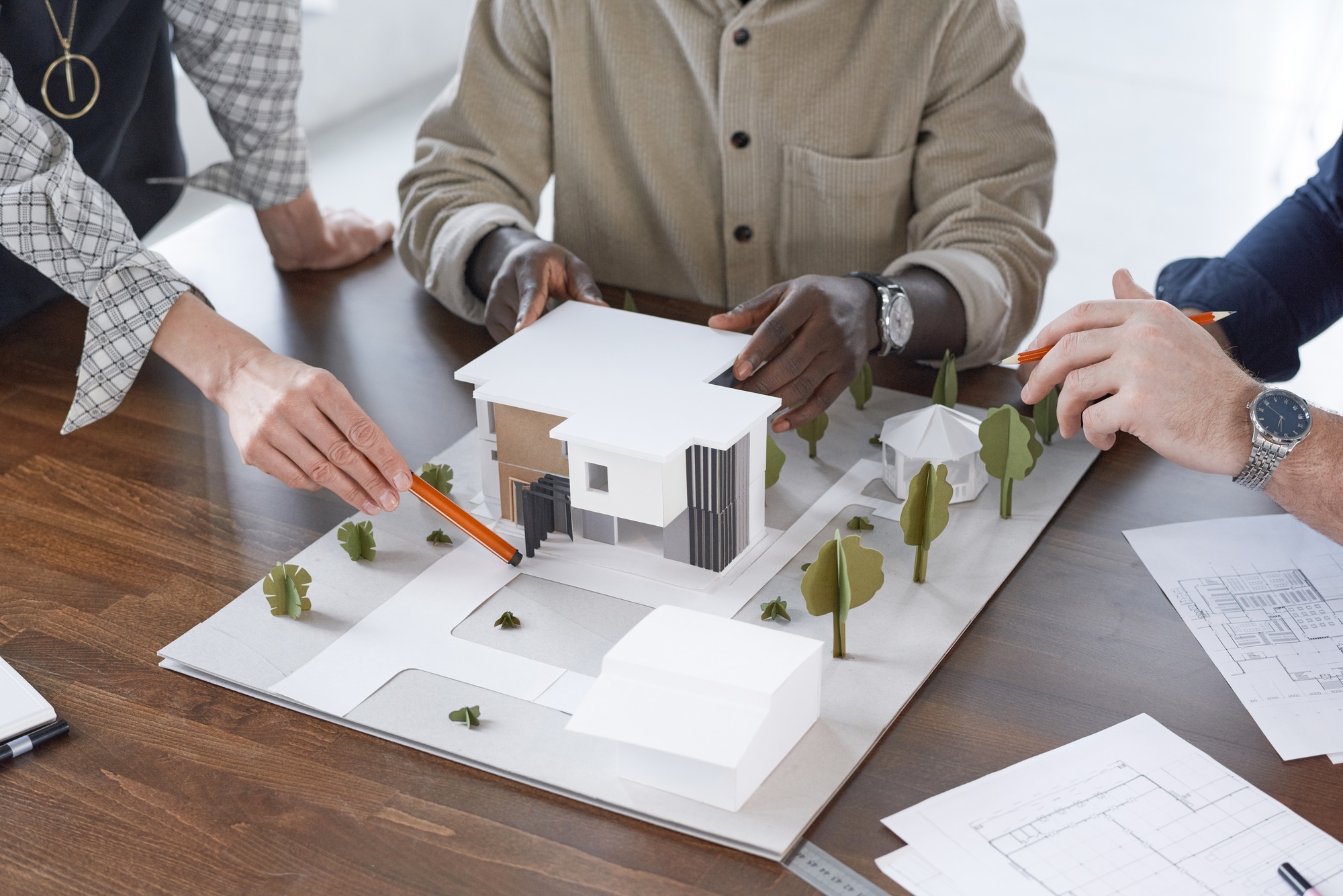 Engineers working with model of building